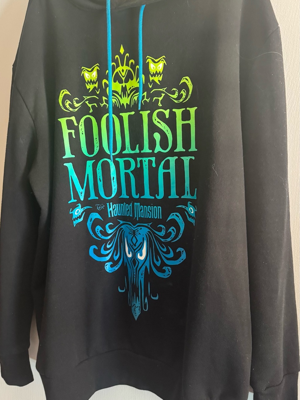 Disney Black Hoodie with Green-to-Teal "Foolish Mortal" Haunted Mansion Graphic
